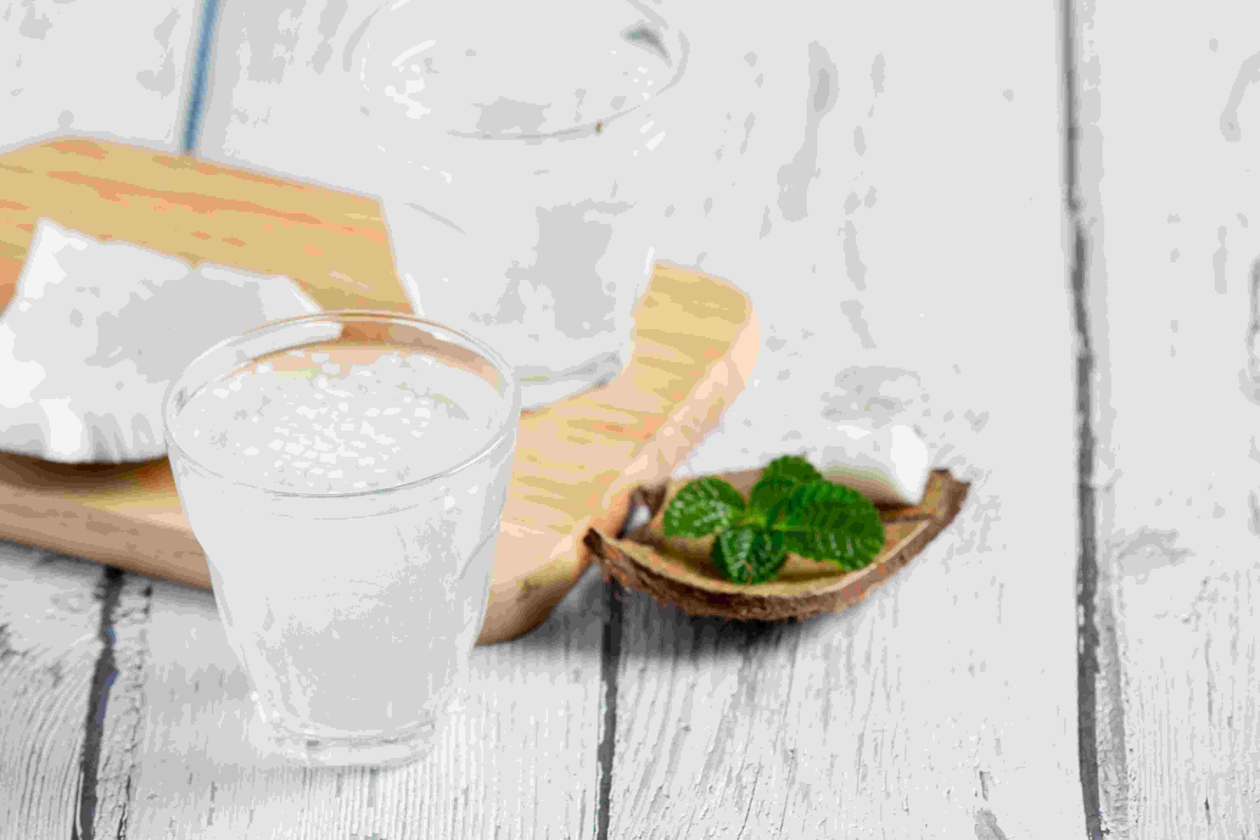 glass coconut water put white wooden background