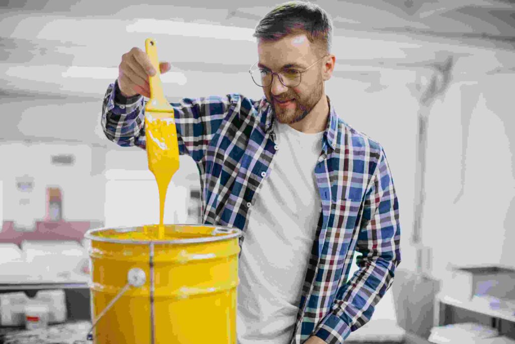 man working printing house with paper paints